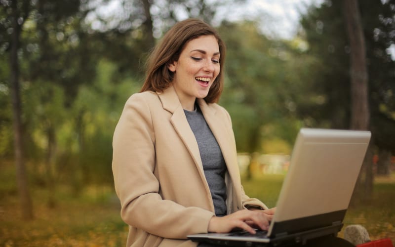 Woman on computer in park